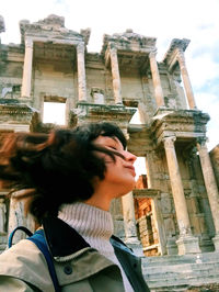 Low angle view of woman shaking head against fort