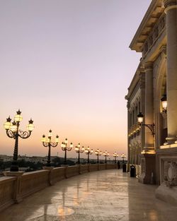 View of city street against sky during sunset