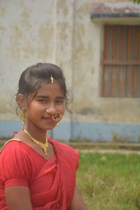 Portrait of smiling young woman standing outdoors