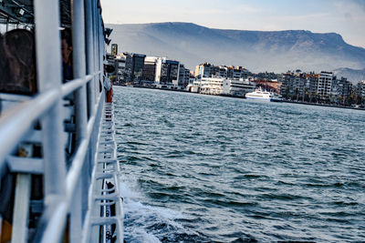 Scenic view of sea by buildings against sky