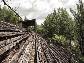 Abandoned structure in forest against sky