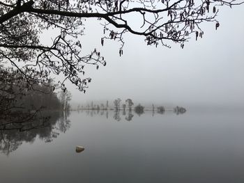 Scenic view of lake against sky during foggy weather