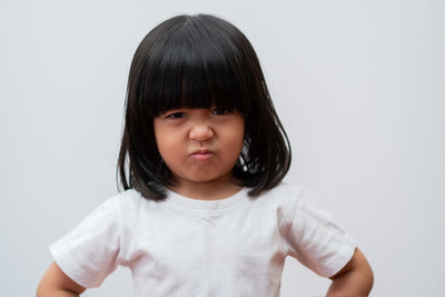 Portrait of cute girl against white background