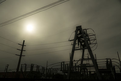 Low angle view of power lines against sky