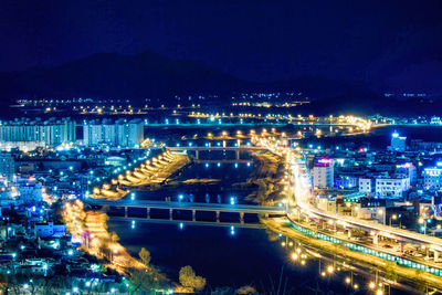 High angle view of illuminated city buildings at night