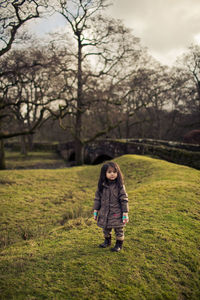 Full length of girl standing on field