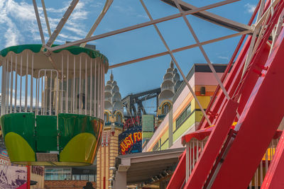 Low angle view of multi colored buildings against blue sky