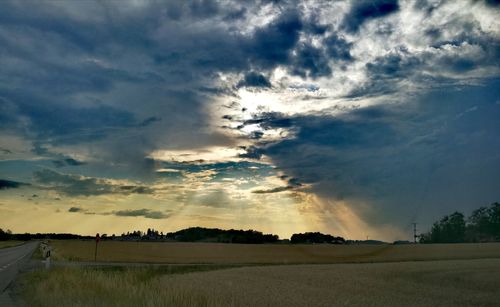 Scenic view of field against sky during sunset