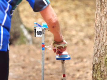Control point in forest orienteering competition, sign hidden in country