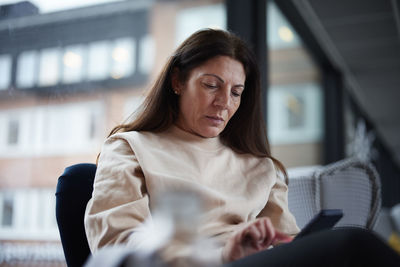 Mature woman using smart phone