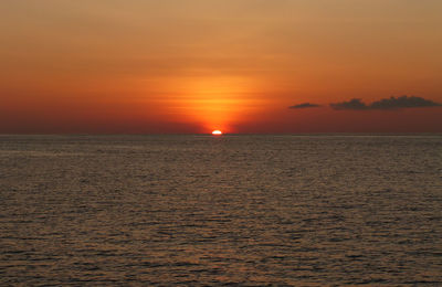 Scenic view of sea against orange sky