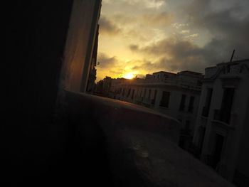 Buildings against sky during sunset