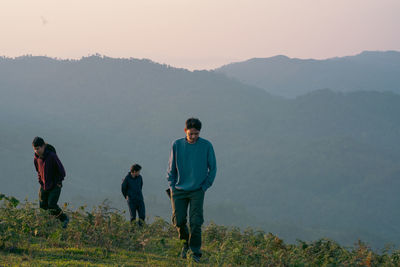 Group of hiker man relax with wellbeing and happy feeling on top of mountain