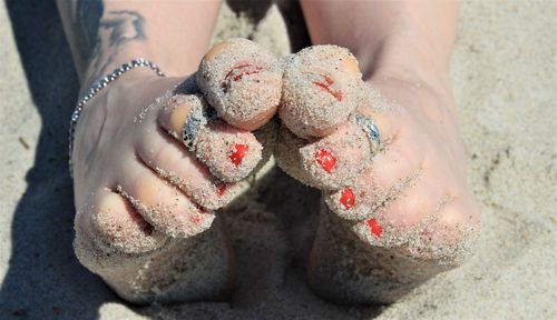 Low section of woman legs on sand