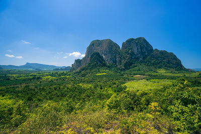 Scenic view of mountains against blue sky