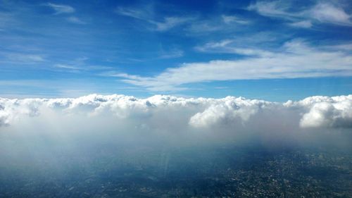 Scenic view of landscape against cloudy sky