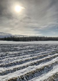 Scenic view of frozen landscape against sky