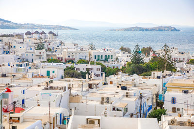 High angle view of townscape by sea against sky