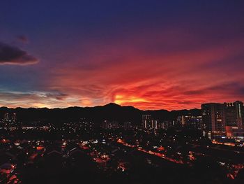 High angle view of illuminated buildings against sky during sunset