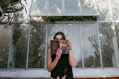 Full length of girl standing against window