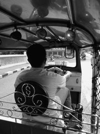 Rear view of man sitting in bus
