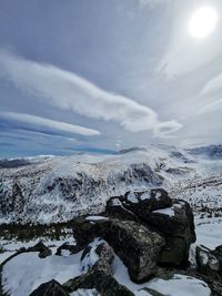 Scenic view of snow covered mountains against sky