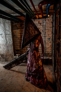 Woman standing on wooden wall