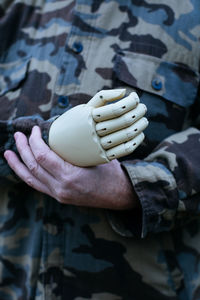Midsection of soldier with prosthetic arm