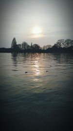 Scenic view of lake at sunset