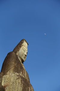 Low angle view of statue against clear blue sky