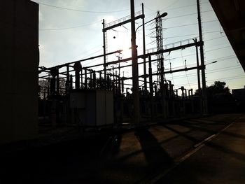 Abandoned factory against sky during sunset