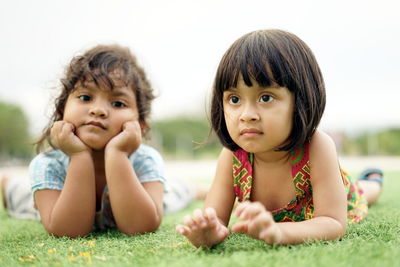 Girls lying on land at park