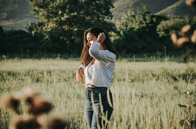 Full length of woman standing on field