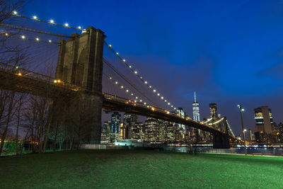 Illuminated bridge against sky at night