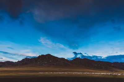 Scenic view of mountains against dramatic sky