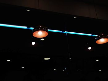 Low angle view of illuminated light hanging on ceiling