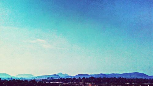 Scenic view of mountains against clear blue sky