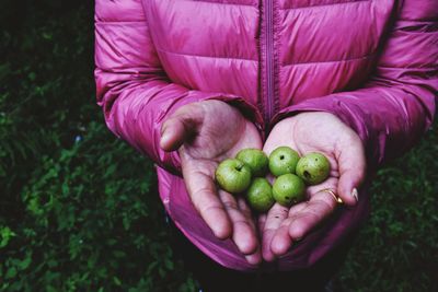 Midsection of woman holding fruit