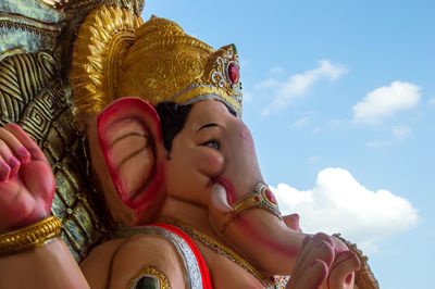 Low angle view of senior woman against sky