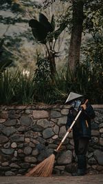 Man holding umbrella while standing on land