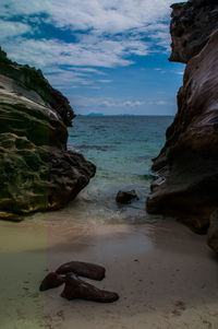Rocks on beach against sky