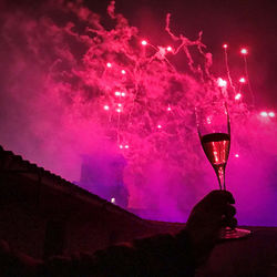 Low angle view of wine glass against sky at night