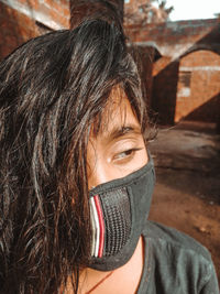 Close-up portrait of woman covering face