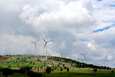 Windmill on field against sky