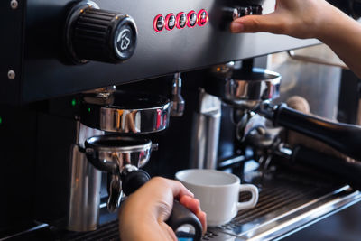 Close-up of hand holding coffee cup