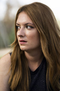 Close up side view of serious blonde woman looking and worried