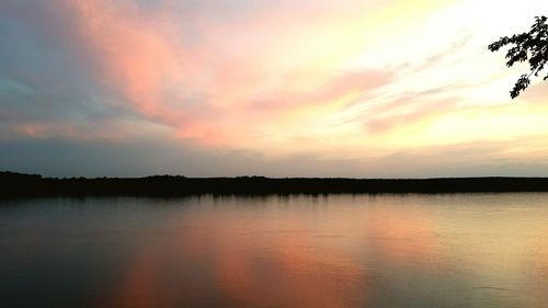 Scenic view of lake against sky at sunset