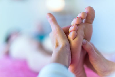 Cropped hands massaging woman foot