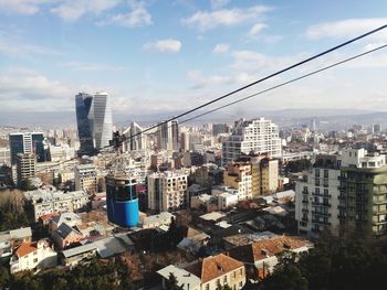 High angle view of buildings in city against sky