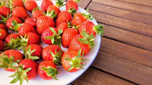 High angle view of strawberries in plate on table